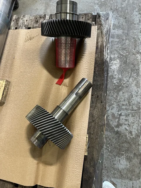 Alternate view of the two components showing shaft shoulders and machined surfaces.