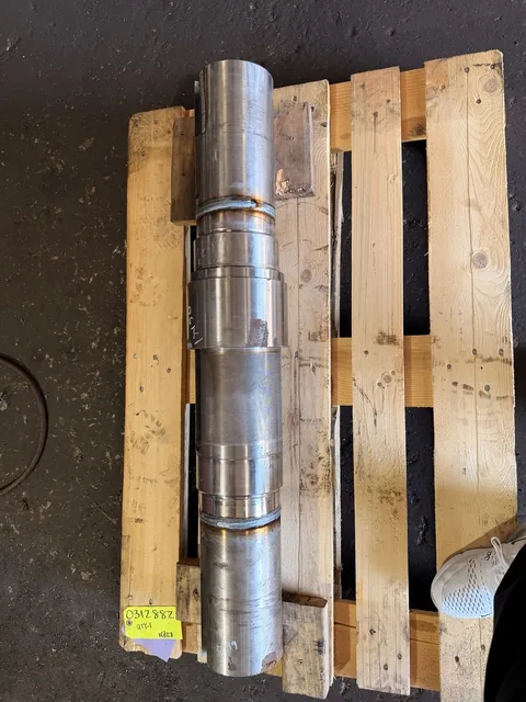 Shaft laid on a pallet, showing bright journal surfaces and a darker central area.