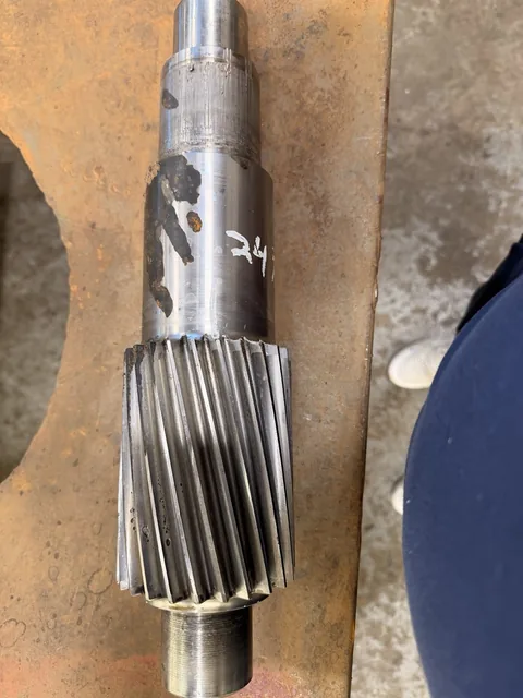 Close-up of pinion teeth and adjacent shaft surfaces.