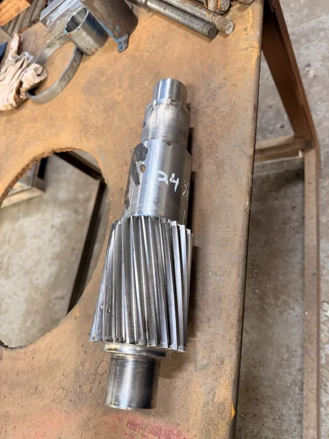 Closer view of the pinion teeth and stepped shaft surfaces.