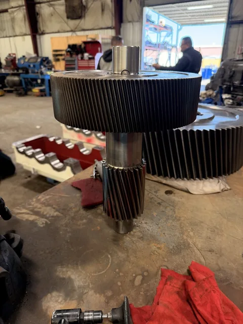 Alternate view of a large helical gear and smaller pinion on one assembly.