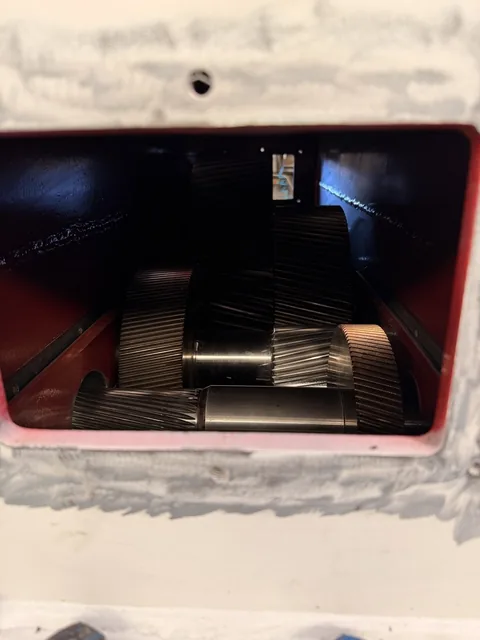 Internal gearing viewed through the housing inspection opening.