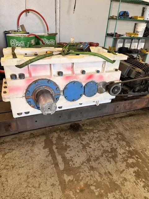 Closed gearbox positioned on a shop setup.